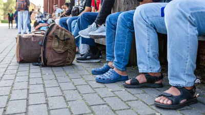 benen van mensen die op een bank zitten op straat